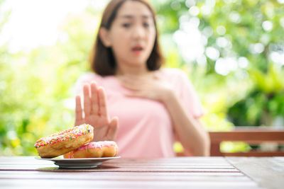 Midsection of woman sitting on table