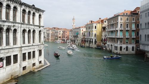 Boats in canal with buildings in background