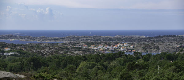 High angle view of townscape by sea against sky