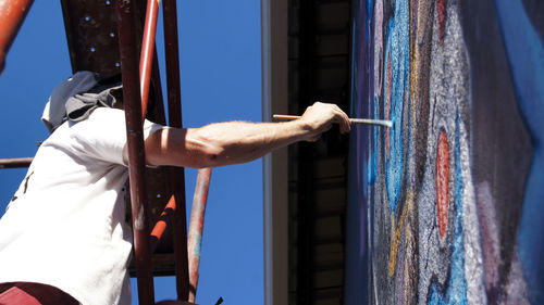 Man making mural on wall