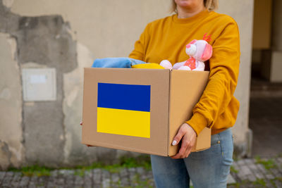 Midsection of man holding gift box