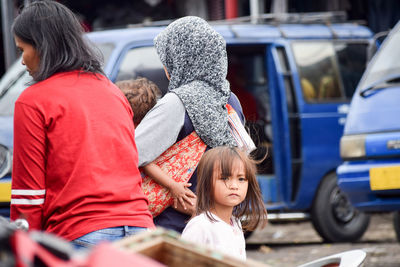 People by vehicle on street 