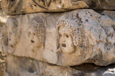 Close-up of statue against stone wall