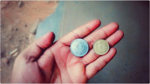 Close-up of hands holding coins