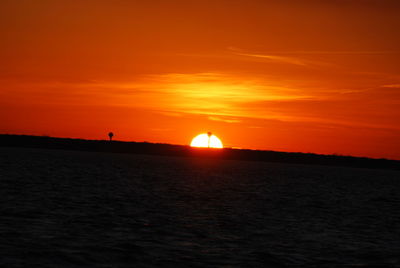 Scenic view of sea against romantic sky at sunset