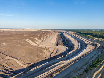 High angle view of road amidst land against sky