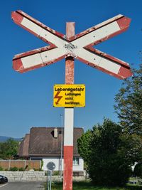 Low angle view of sign board against sky