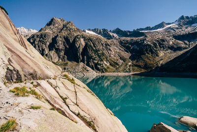Scenic view of mountains against clear blue sky