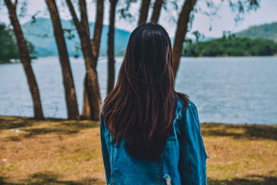 Rear view of woman standing in water