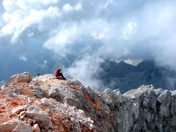 Woman on mountain range against sky