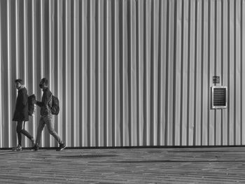 People standing against wall