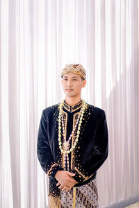 Asian man wearing traditional clothes,beskap is traditional heritage clothes from java,indonesia 