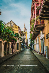 Street amidst buildings against sky