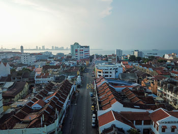 High angle view of buildings in city against sky