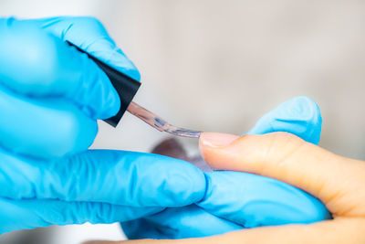 Close-up of woman hand holding finger