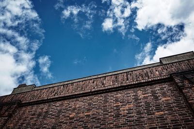 Low angle view of building against cloudy sky