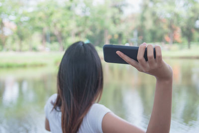 Rear view of woman using mobile phone