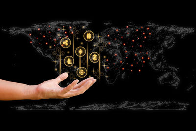 Digital composite image of man hand against black background