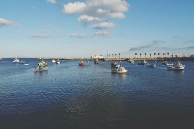 Boats in sea against sky