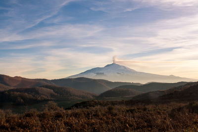 Scenic view of mountain against cloudy sky