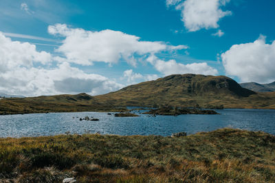 Scenic view of lake and mountains against sky