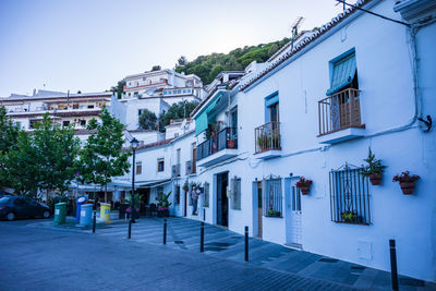 Street amidst buildings in city against sky