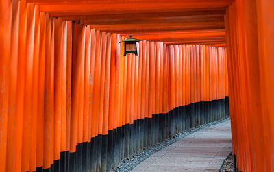 Corridor of building against orange sky