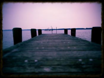 Pier over sea against clear sky