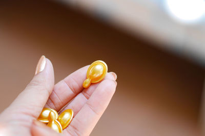 Cropped hand of woman holding objects