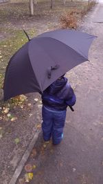 Rear view of boy standing on ground