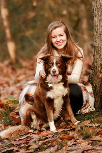 Portrait of a smiling young woman with dog