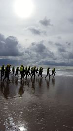 People on beach against sky