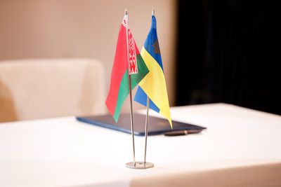 Red green national flag of belarus and blue yellow flag of ukraine. minsk ceasefire talks between 