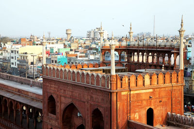 Jama masjid by cityscape against clear sky