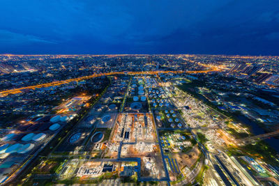 High angle view of city lit up at night