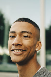 Portrait of smiling teenage boy in city