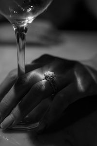 Cropped hand of woman holding drink at table