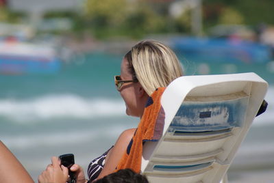 Woman holding mobile phone in water