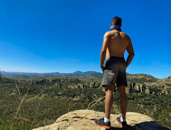 Rear view of man standing on mountain road