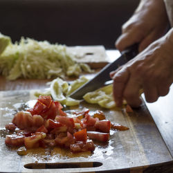 Human hand slicing vegetables