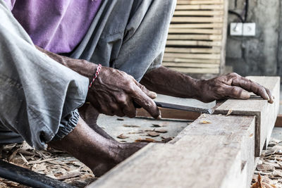 Low section of carpenter with wood working outdoors