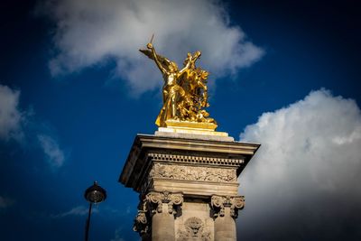 Low angle view of statue against cloudy sky