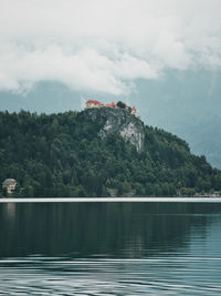 Moody scenes at lake bled, slovenia. castle on a rock against fog.