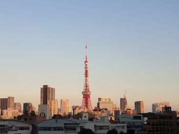 View of buildings in city against clear sky