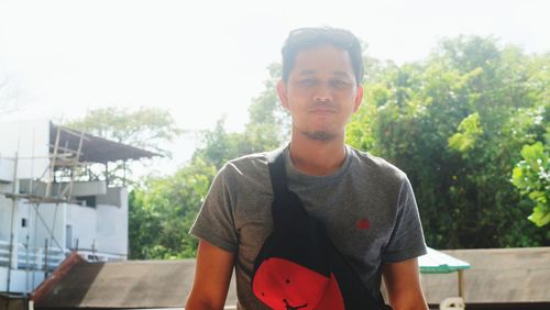 Portrait of young man standing outdoors