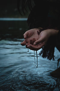 Close-up of person holding water drop