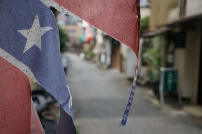 Close-up of flag hanging by street