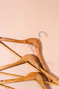 High angle view of wooden spoons against pink background