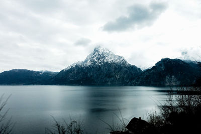 Scenic view of lake and mountains against sky