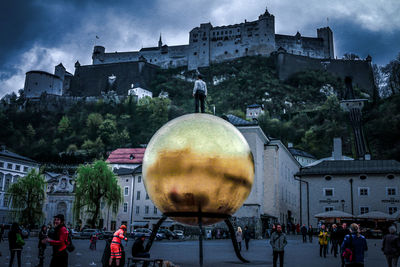 Group of people in city against buildings
